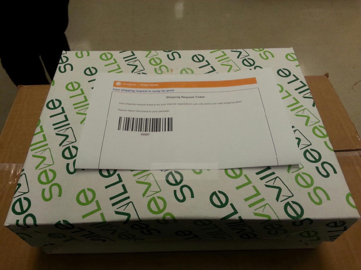 An example of a smaller package with ship ticket folded in half with barcode side up, affixed to shipment with two small pieces of tape. An example of a smaller package with ship ticket folded in half with barcode side up, affixed to shipment with two small pieces of tape.