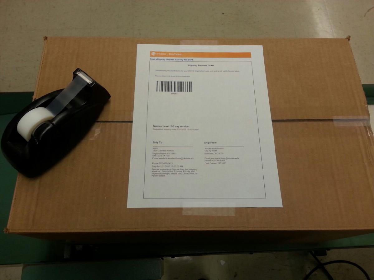 Image of package with example ship ticket affixed with two small pieces of tape. Image of package with example ship ticket affixed with two small pieces of tape.